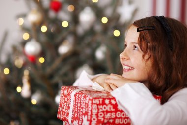 Pretty young girl dreaming of Christmas clipart