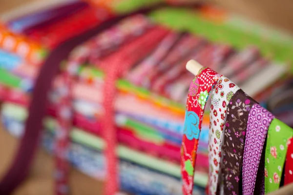 Various Laces Hanging With Clothes In Background At Workshop — Stock Photo, Image