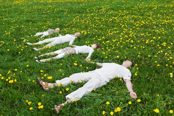 Family relaxing on green grass — Stock Photo, Image