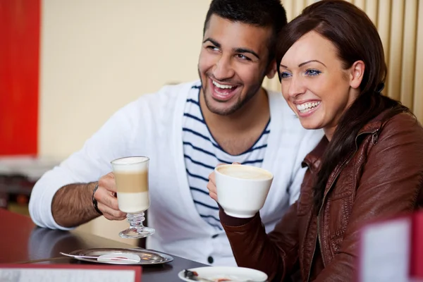 Laughing young couple in a restaurant — Stock Photo, Image