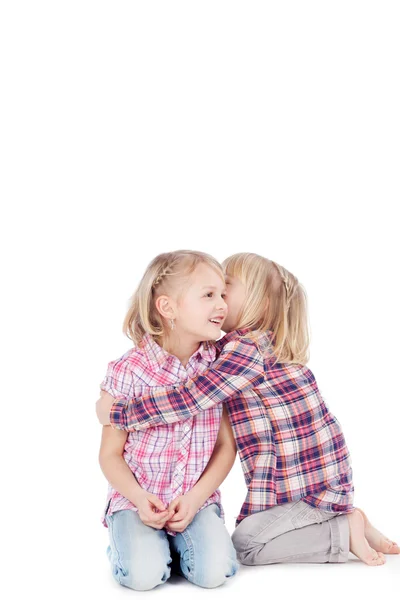 Girl Sharing Secret With Sister Against White Background — Stock Photo, Image