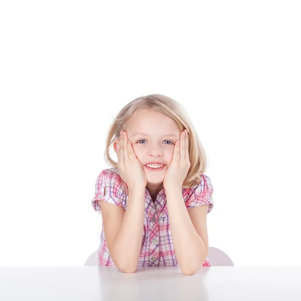 Girl With Hands On Cheeks Sitting At Table — Stock Photo, Image