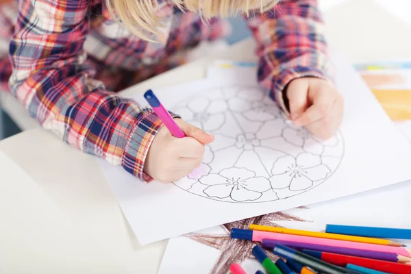 Little girl colouring in a medallion — Stock Photo, Image
