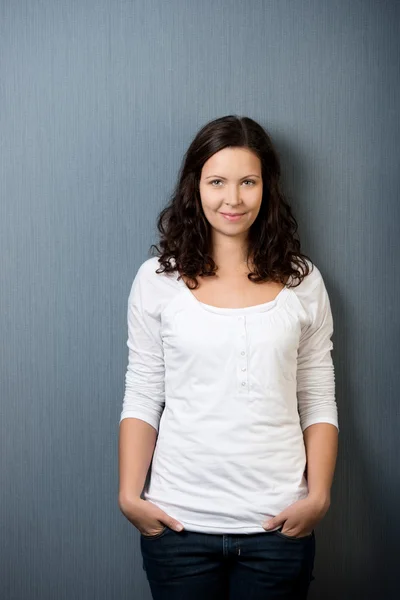 Woman In Casuals Standing Against Wall — Stock Photo, Image