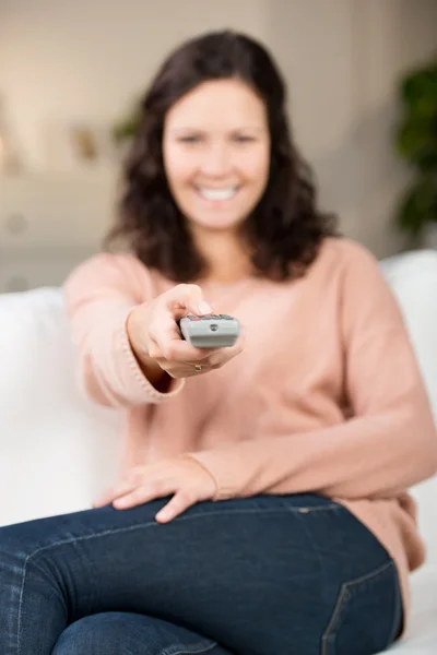 Woman with a remote control — Stock Photo, Image