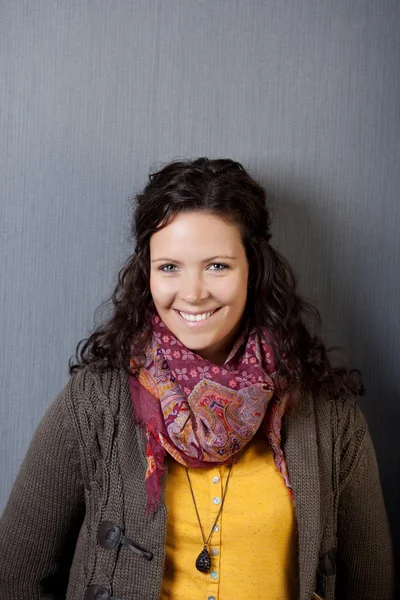Woman In Winter Clothes Smiling Against Gray Wall — Stock Photo, Image