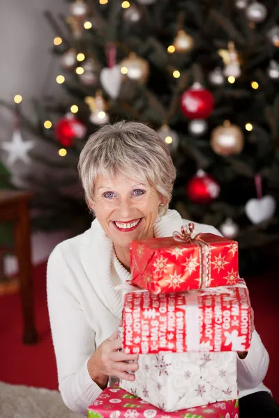 Happy grandmother with Christmas gifts — Stock Photo, Image