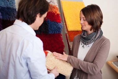 Couple choosing a carpet clipart