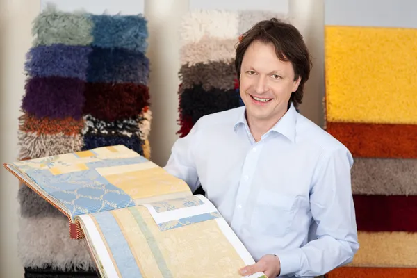 Friendly salesman with fabric samples — Stock Photo, Image