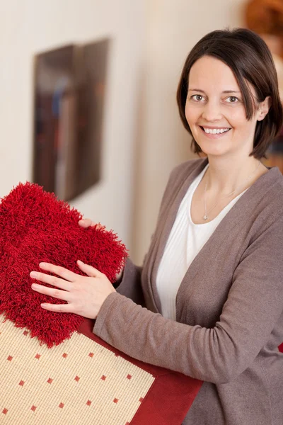 Lachende vrouw met tapijt monsters — Stockfoto