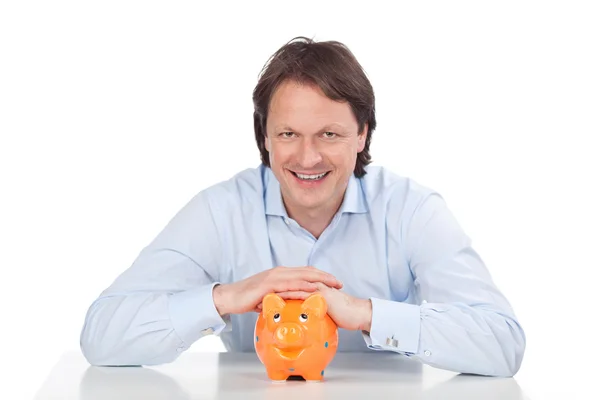 Hopeful man and piggy bank — Stock Photo, Image