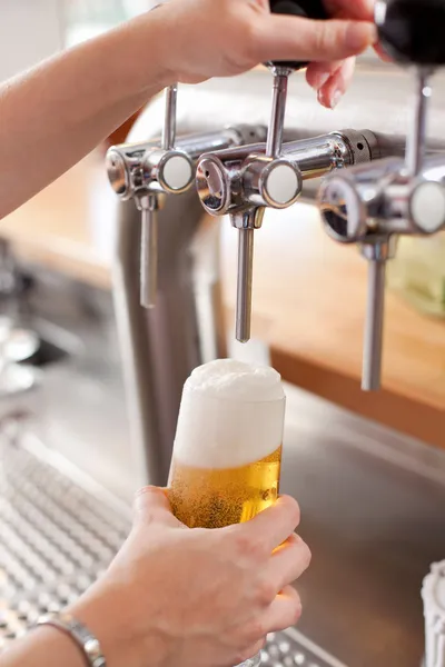 Bartender pouring draft beer — Stock Photo, Image