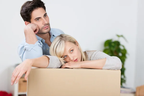 Tired Couple Leaning On Cardboard Box — Stock Photo, Image