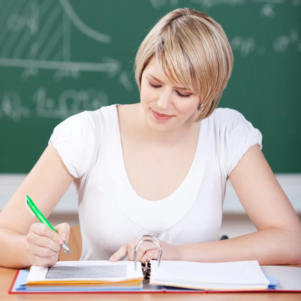 Attractive female student working in class — Stock Photo, Image