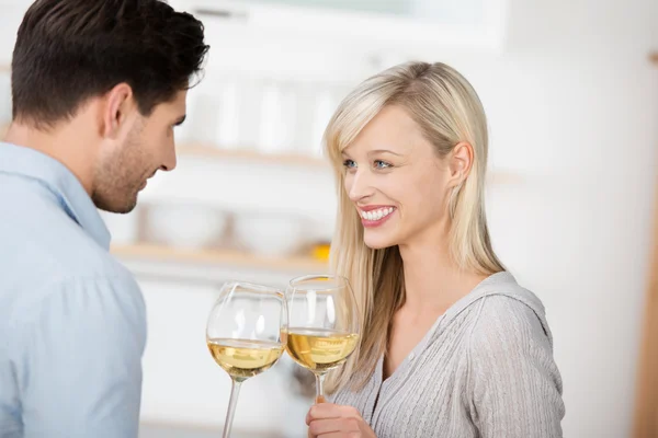 Couple Toasting Wine Glasses In Kitchen Royalty Free Stock Photos