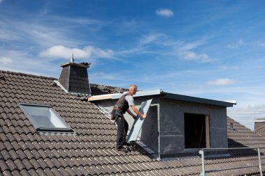 Roofer carrying a metal piece to the dormer clipart
