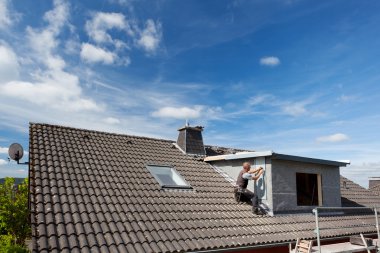 View of a rooftop with a working roofer clipart