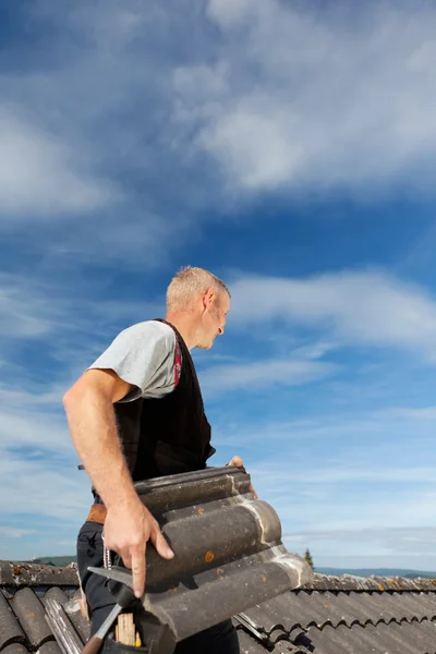 Roofing carrying tiles on rooftop — Stock Photo, Image