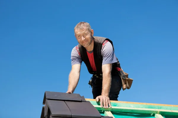 Smiling roofer on top of the roof — Stock Image Smiling roofer on top of the roof Royalty Free Stock Images