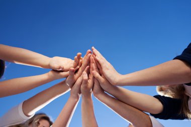 Hands Together Against Clear Blue Sky clipart