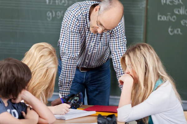 Group activity at school with a teacher — Stock Photo, Image