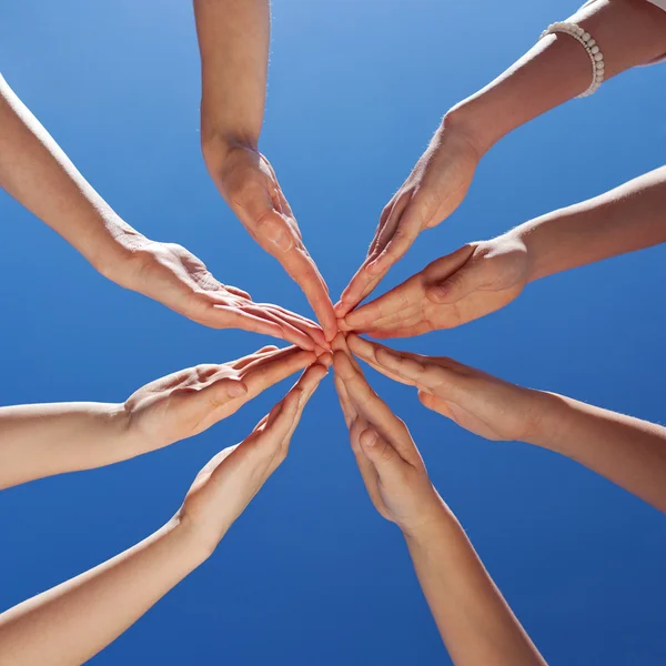 Students And Teacher 's Hands Together Against Sky — стоковое фото