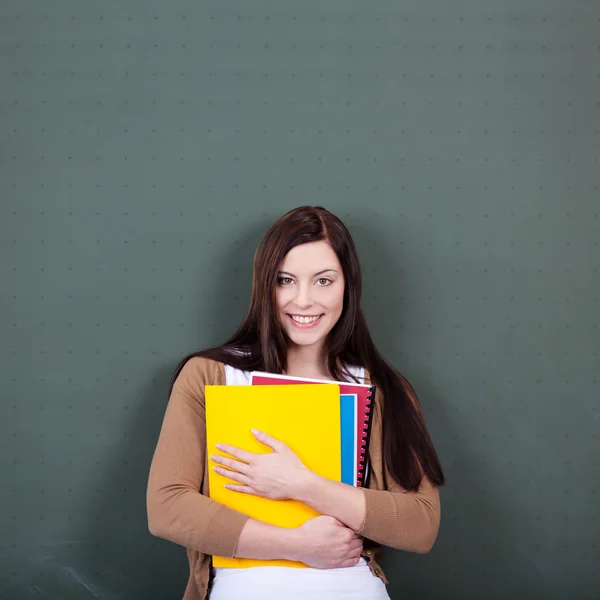 Frau hält Akten gegen Tafel im Klassenzimmer — Stockfoto