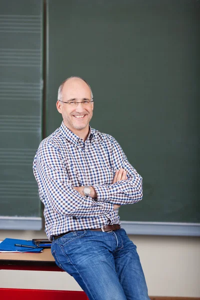 Professor With Arms Crossed Sitting On Desk — Stock Photo, Image