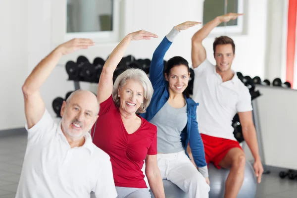 Grupo de personas haciendo aeróbicos en el gimnasio — Foto de Stock