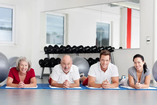 Family Lying On Mat In Gym — Stock Photo, Image
