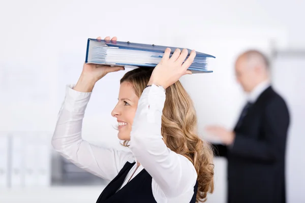 Businesswoman with a binder on her head — Stock Photo, Image