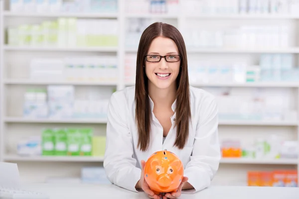 Pharmacist with piggybank — Stock Photo, Image