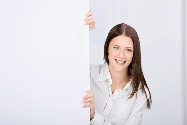 Beautiful young female holding a white board — Stock Photo, Image