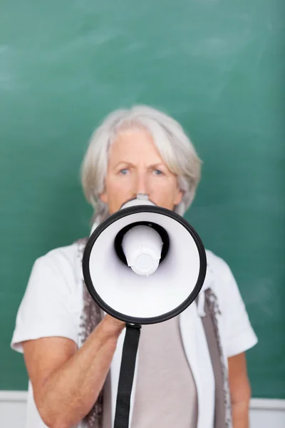 Insegnante senior che parla in megafono contro la lavagna — Foto Stock