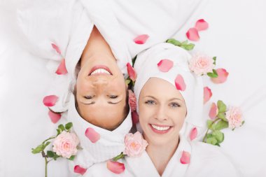 Two smiling friends in a spa clipart
