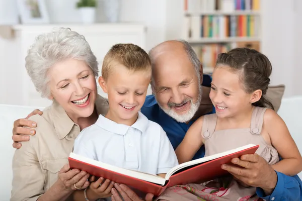 Boy and girl looking at a photo album — Stock Photo, Image