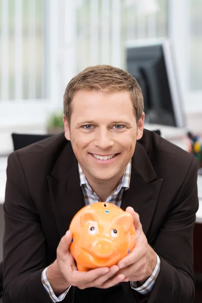 Businessman holding a piggy bank — Stock Photo, Image