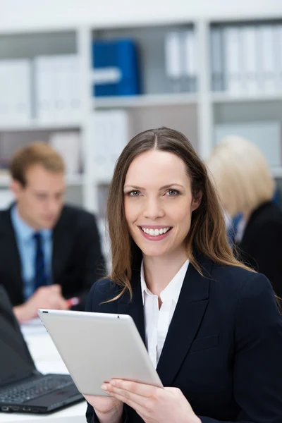 Attractive businesswoman holding a tablet-pc — Stock Photo, Image