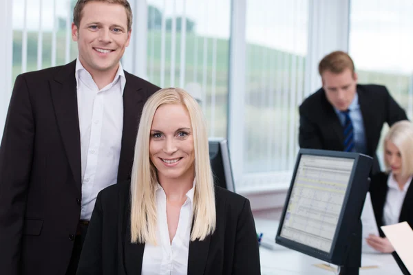 Coworkers in a busy corporate office — Stock Photo, Image