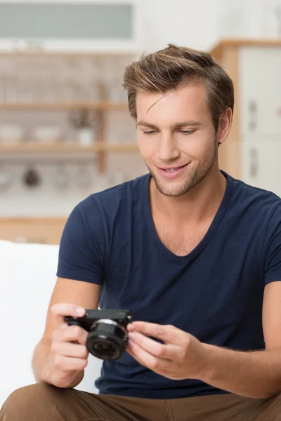 Man smiling as he checks an image on his camera — Stock Photo, Image