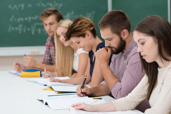 Group of students at work in the classroom — Stock Photo, Image