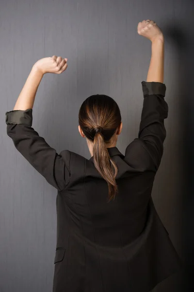 Businesswoman stretching her arms — Stock Photo, Image