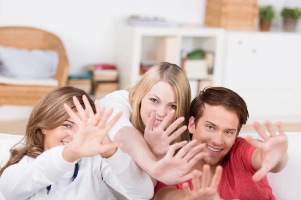 Laughing teenagers holding out their hands — Stock Photo, Image