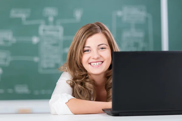 Smiling teenage girl in a college classroom — Stock Photo, Image