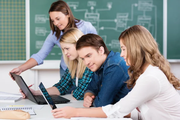 Young teenage students working in class — Stock Photo, Image