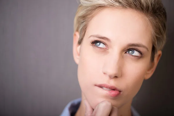 Attractive woman with a thoughtful expression — Stock Photo, Image