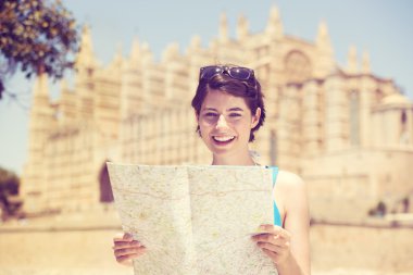 Woman sightseeing with a map clipart