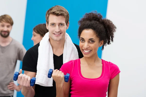 Multiethnic couple working out with dumbbells — Stock Photo, Image