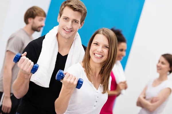 Enthusiastic couple working out with dumbbells — Stock Photo, Image