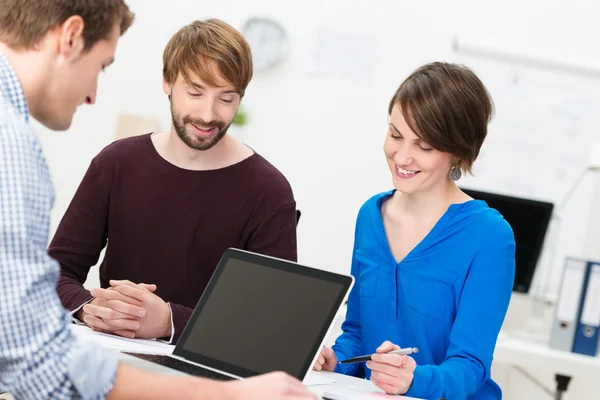 Three happy co-workers in a meeting — Stock Photo, Image